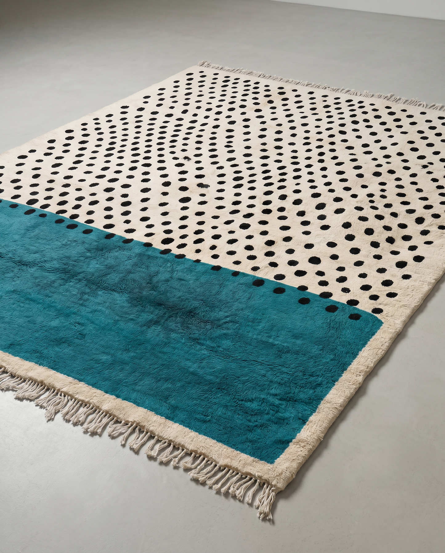 SIHAM Mrirt cream color block polka dot Moroccan rug displayed on a parquet wood floor, showing full fringe and edge detail, by NURA