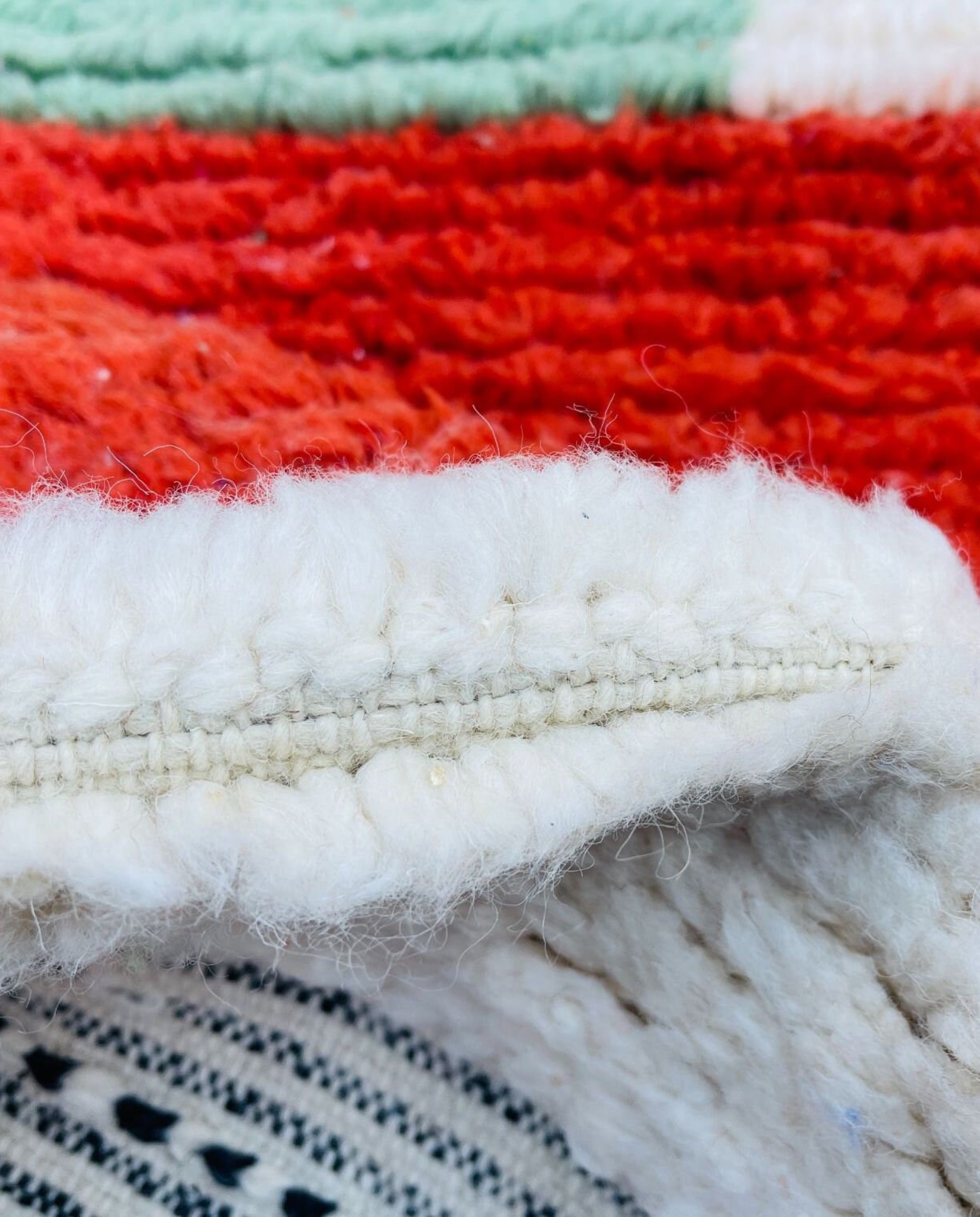 SOUKAINA Azilal cream abstract color block Moroccan rug close-up showing hand-knotted wool texture and pile detail 3, by NURA