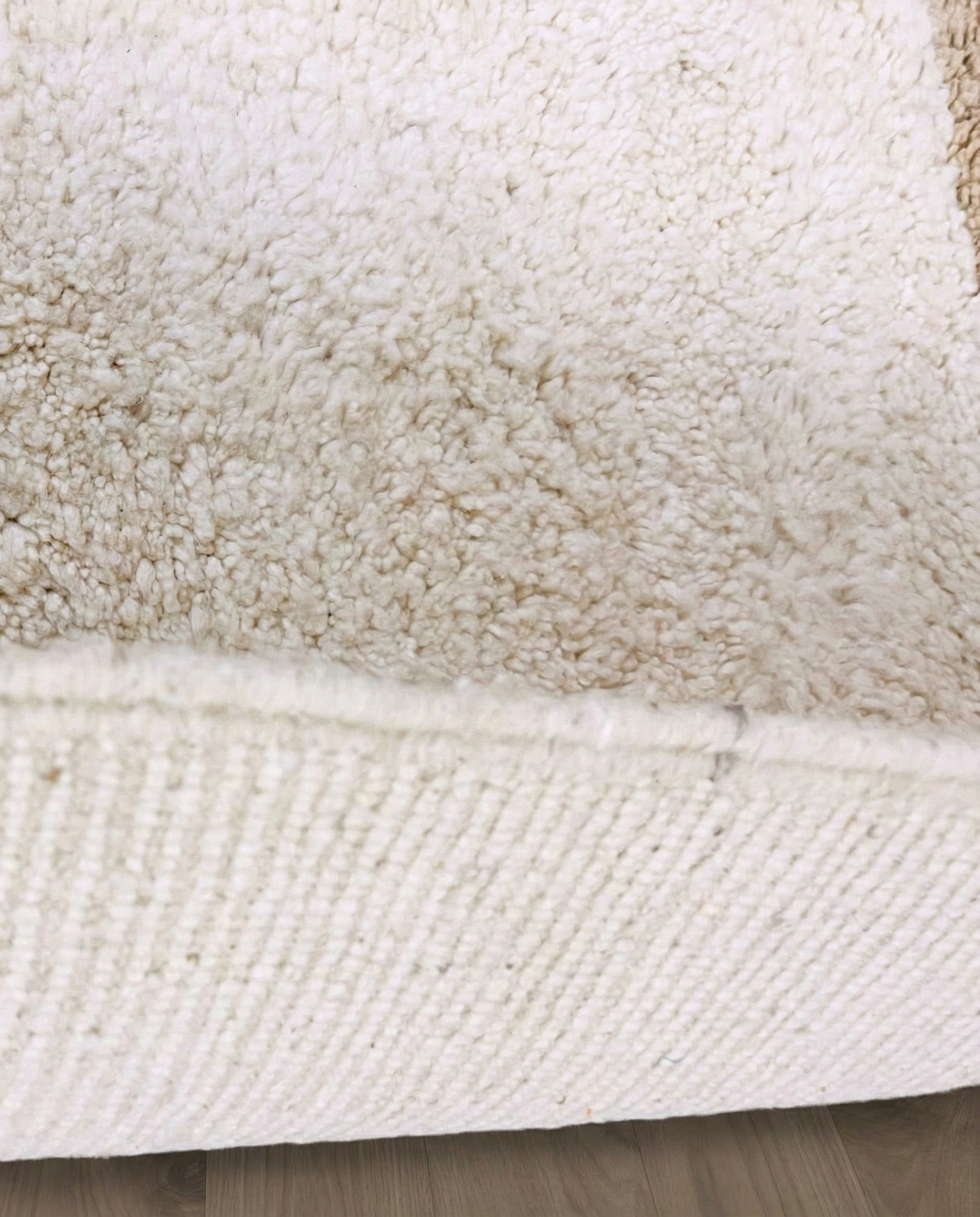 SOUMAYA Beni Ourain cream abstract stepped blocks Moroccan rug close-up showing hand-knotted wool texture and pile detail 2, by NURA