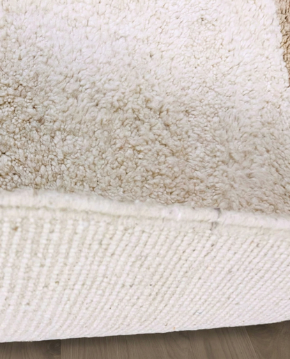 SOUMAYA Beni Ourain cream abstract stepped blocks Moroccan rug close-up showing hand-knotted wool texture and pile detail 2, by NURA
