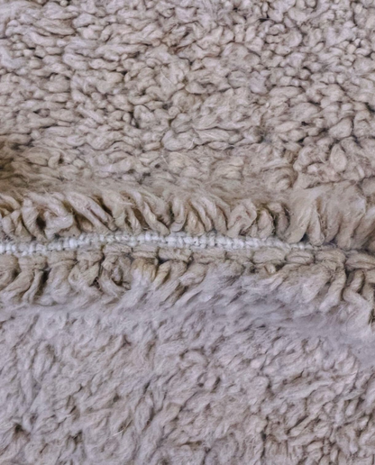 SOUMAYA Beni Ourain cream abstract stepped blocks Moroccan rug close-up showing hand-knotted wool texture and pile detail 3, by NURA