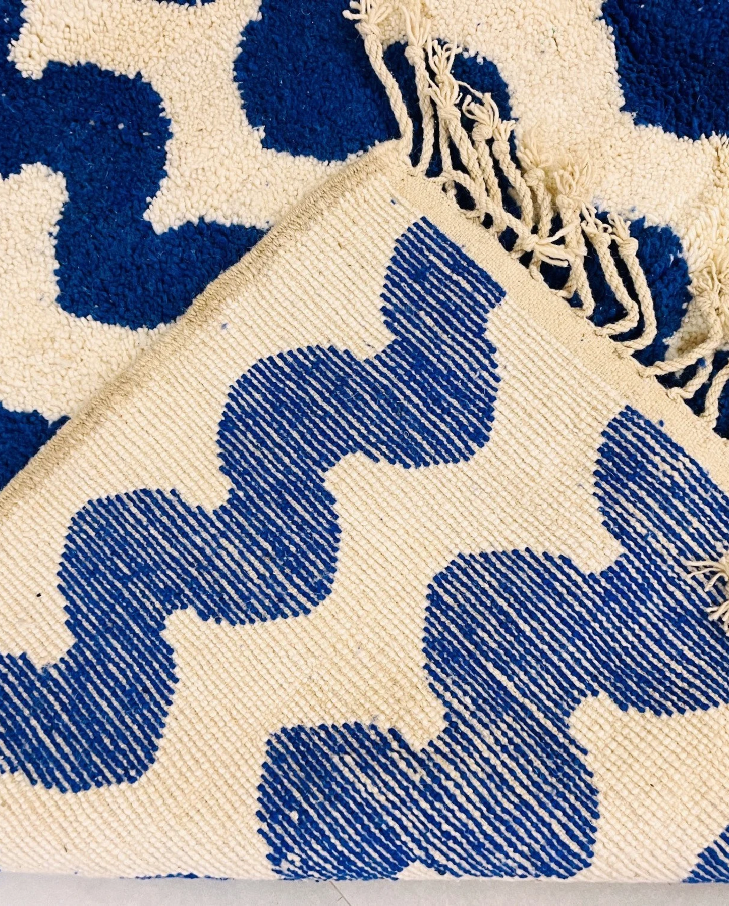 SOUMIA Beni Ourain cobalt wavy striped field Moroccan rug back view showing traditional handwoven construction, by NURA