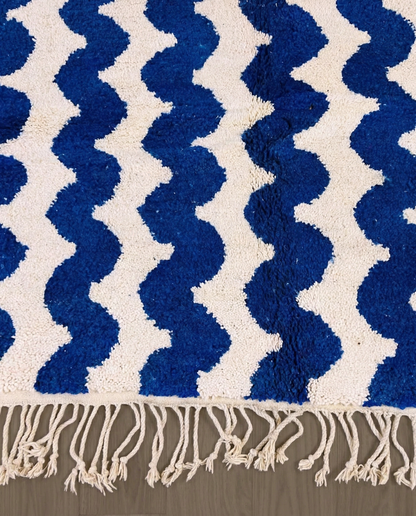 SOUMIA Beni Ourain cobalt wavy striped field Moroccan rug close-up of hand-tied fringe and kilim band detail, by NURA