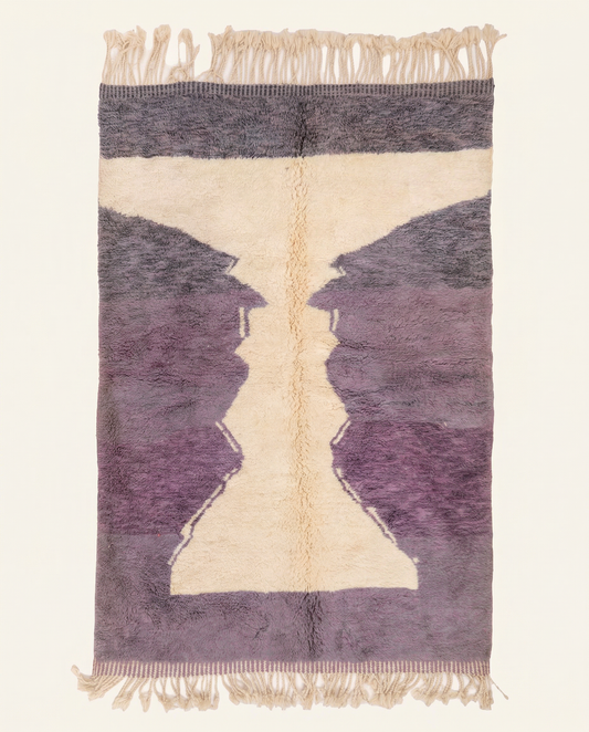Plush plum purple Boujad Moroccan rug with a bold cream abstract hourglass motif and dense hand-knotted high pile, by NURA.