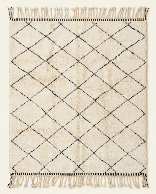 Plush cream Beni Ourain Moroccan rug with a large black diamond lattice and thick natural wool pile, by NURA.