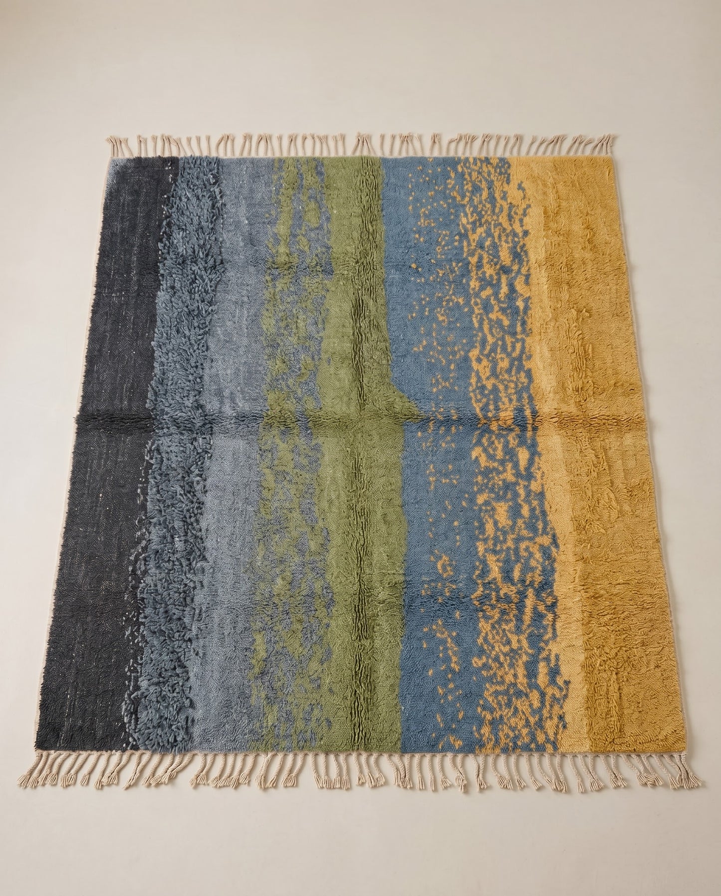 WISSAL Mrirt slate blue organic abstract Moroccan rug displayed on a parquet wood floor, showing full fringe and edge detail, by NURA