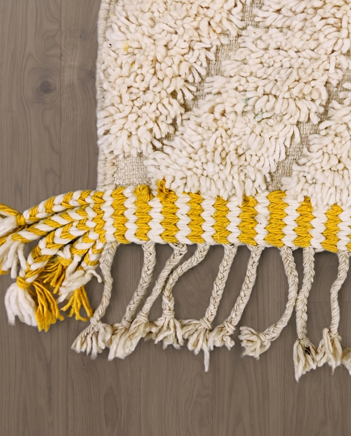 YARA Beni Ourain ivory bold diamond lattice Moroccan rug close-up of hand-tied fringe and kilim band detail, by NURA