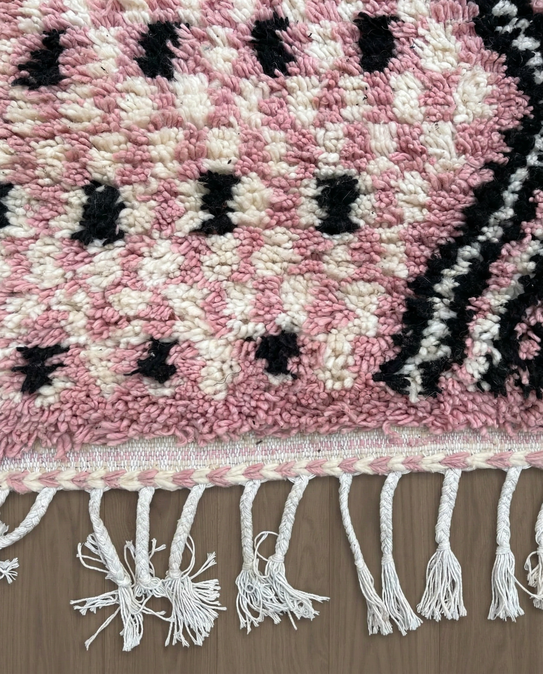 YOUSRA Azilal pink bold diamond lattice Moroccan rug close-up of hand-tied fringe and kilim band detail, by NURA