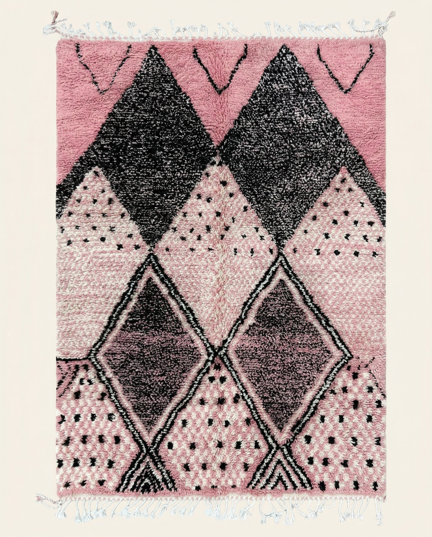 Plush pink Azilal Moroccan rug featuring a bold black interlocking diamond lattice and scattered dots, by NURA.