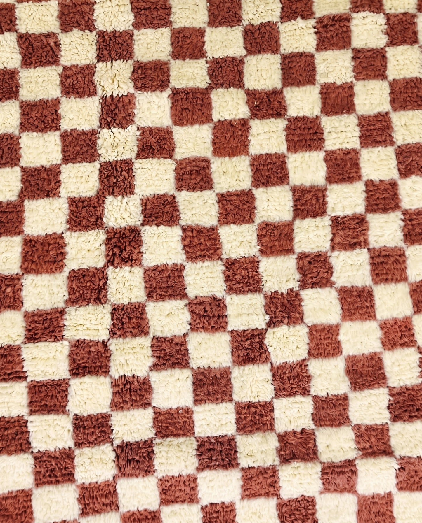 ZAHIA Beni Ourain terracotta checker grid Moroccan rug close-up showing hand-knotted wool texture and pile detail 1, by NURA