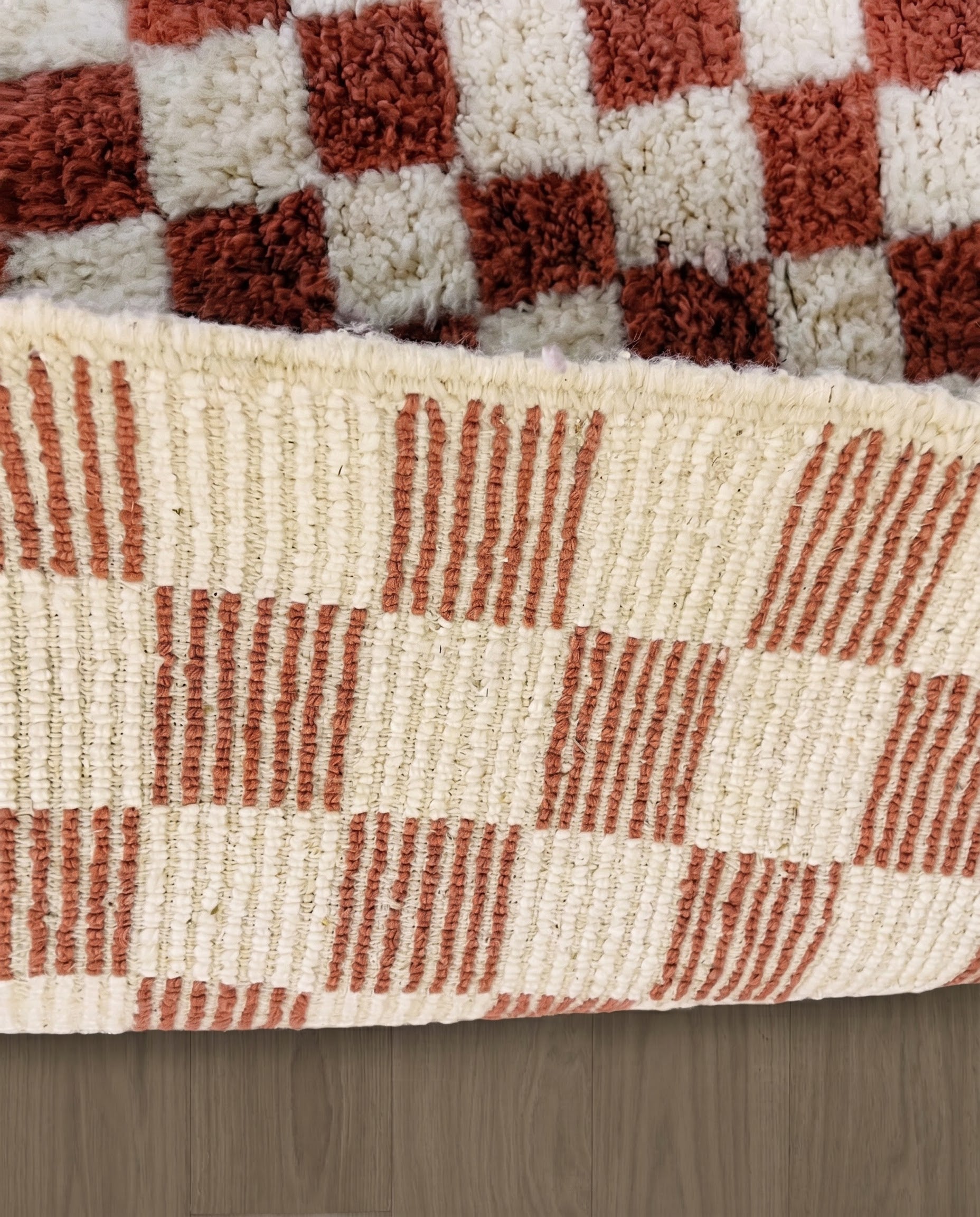 ZAHIA Beni Ourain terracotta checker grid Moroccan rug close-up showing hand-knotted wool texture and pile detail 2, by NURA