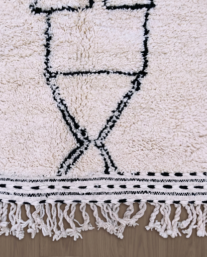 ZAINA Beni Ourain ivory panelled checkerboard Moroccan rug close-up of hand-tied fringe and kilim band detail, by NURA