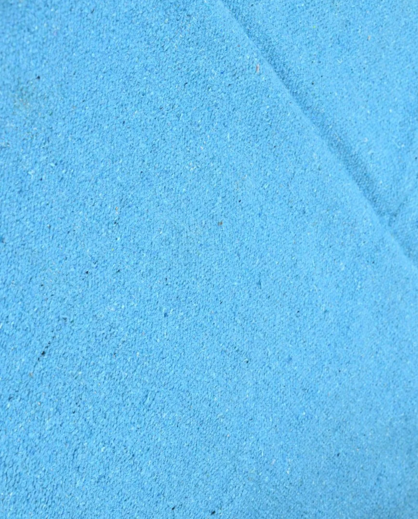 ZAYDA Azilal azure solid field Moroccan rug close-up showing hand-knotted wool texture and pile detail, by NURA