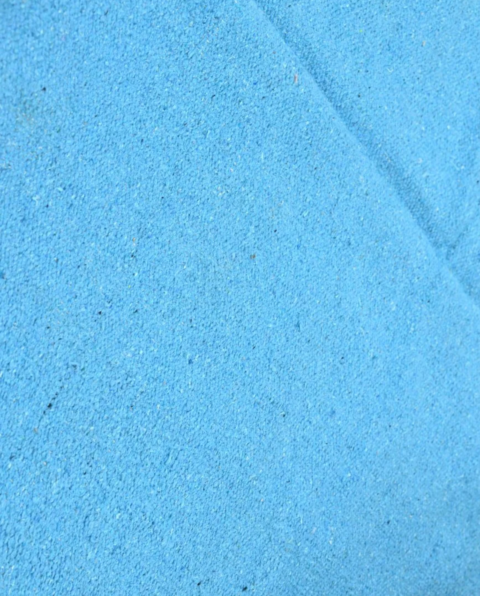 ZAYDA Azilal azure solid field Moroccan rug close-up showing hand-knotted wool texture and pile detail, by NURA