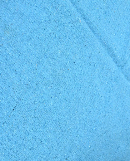 ZAYDA Azilal azure solid field Moroccan rug close-up showing hand-knotted wool texture and pile detail, by NURA