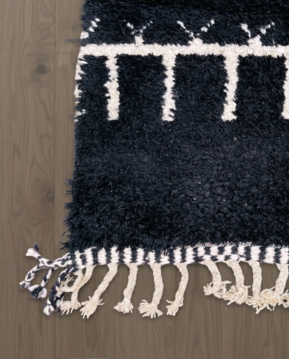 ZOHRA Beni Ourain black horizontal geometric bands Moroccan rug close-up of hand-tied fringe and kilim band detail, by NURA