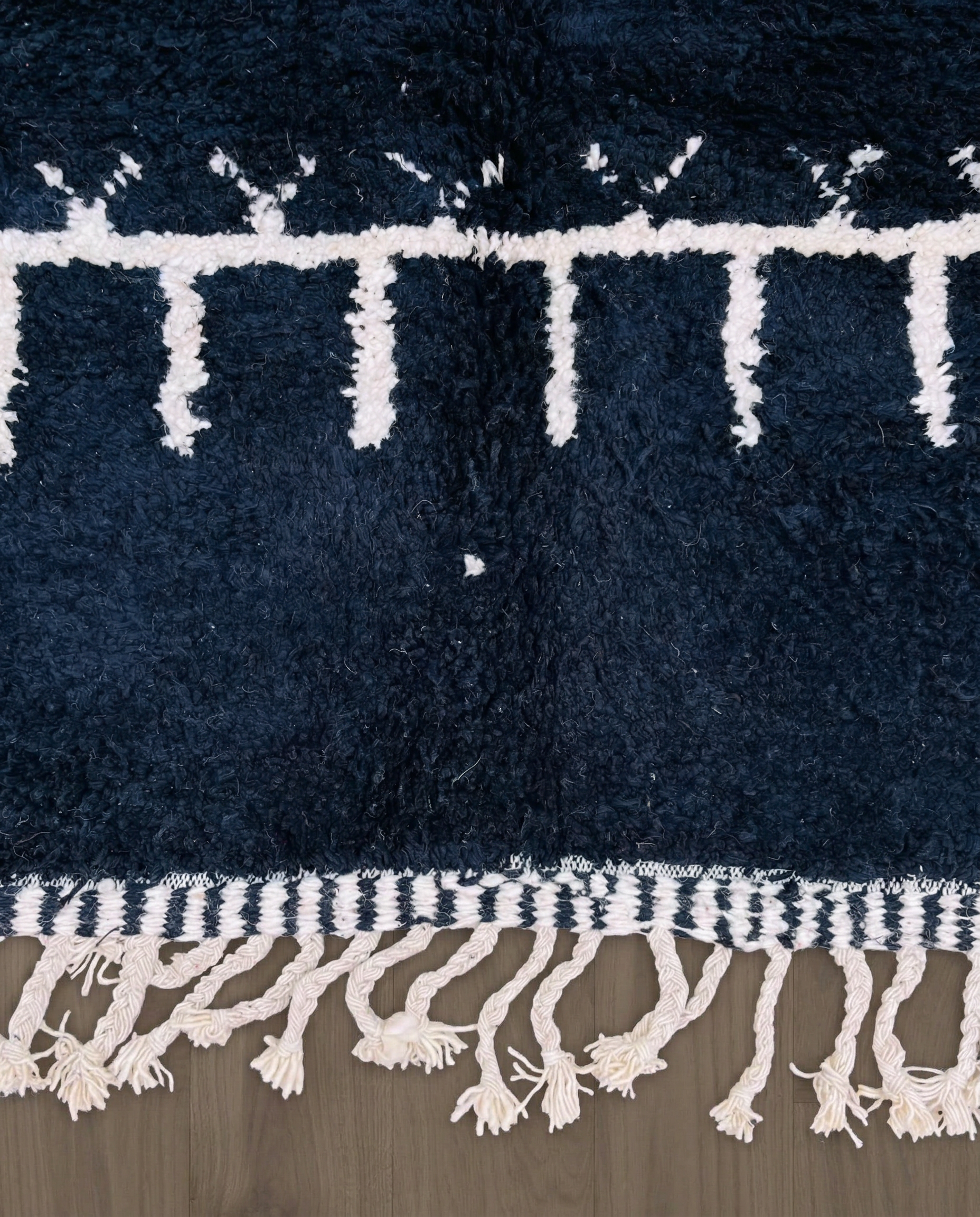 ZOHRA Beni Ourain black horizontal geometric bands Moroccan rug close-up showing hand-knotted wool texture and pile detail 2, by NURA