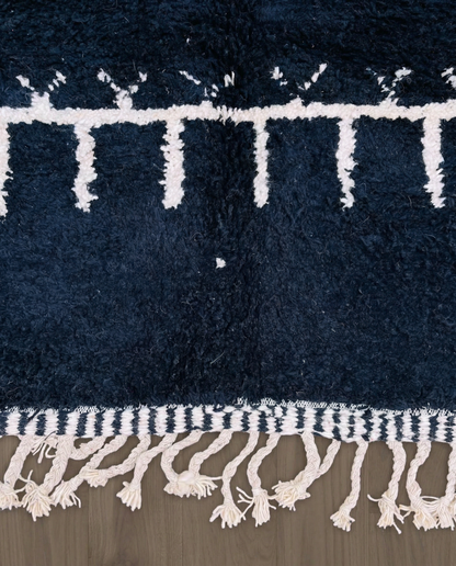 ZOHRA Beni Ourain black horizontal geometric bands Moroccan rug close-up showing hand-knotted wool texture and pile detail 2, by NURA