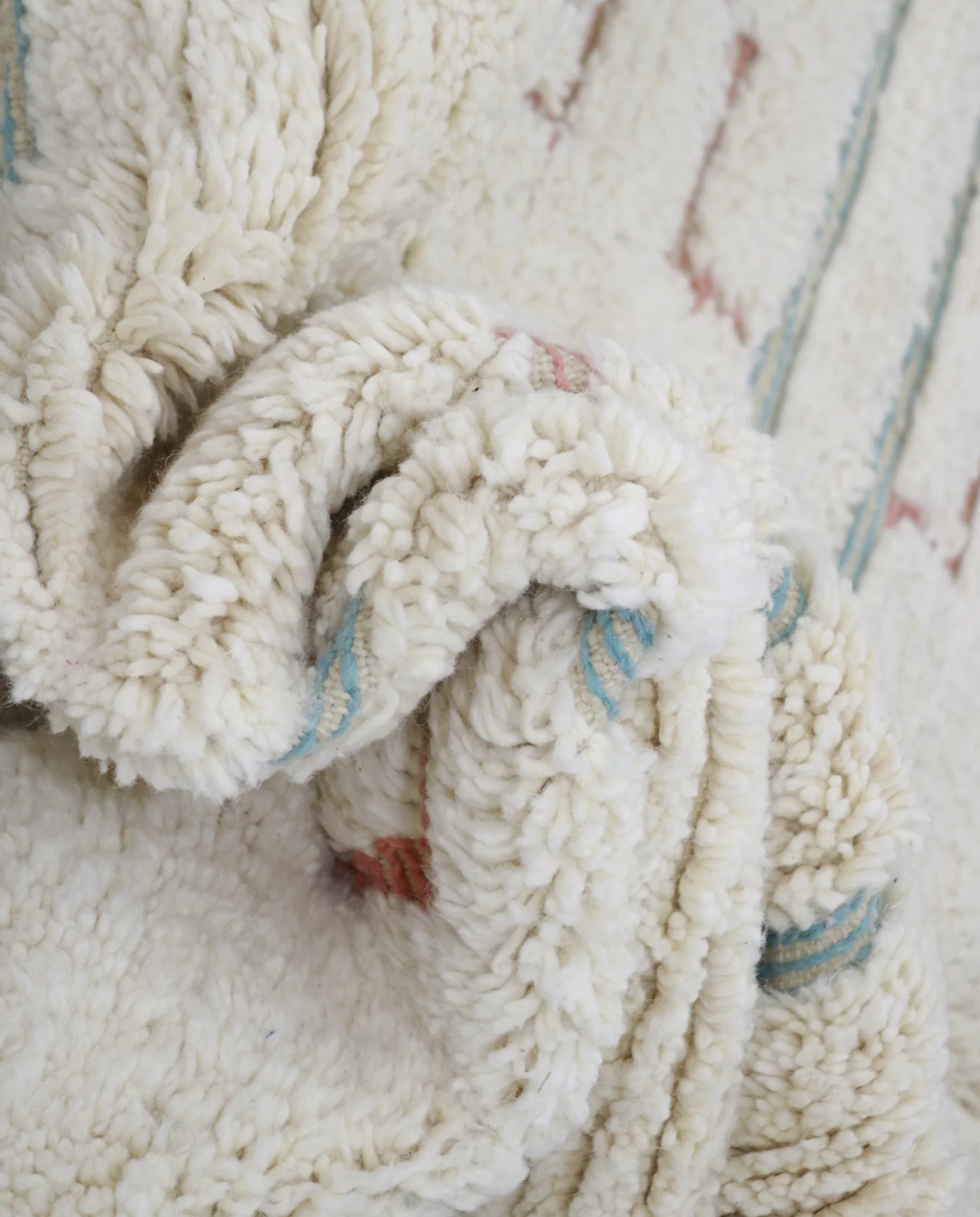 ZOUBIDA Beni Ourain cream floating forms Moroccan rug close-up showing hand-knotted wool texture and pile detail, by NURA