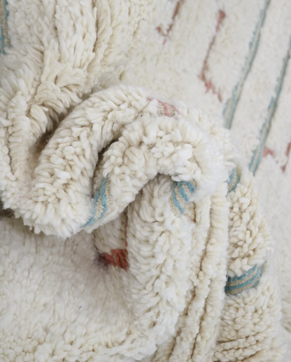 ZOUBIDA Beni Ourain cream floating forms Moroccan rug close-up showing hand-knotted wool texture and pile detail, by NURA