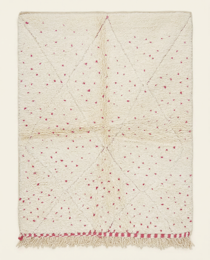 Plush cream Beni Ourain Moroccan rug with a subtle diamond lattice and scattered hot pink dots, by NURA.
