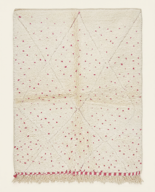 Plush cream Beni Ourain Moroccan rug with a subtle diamond lattice and scattered hot pink dots, by NURA.